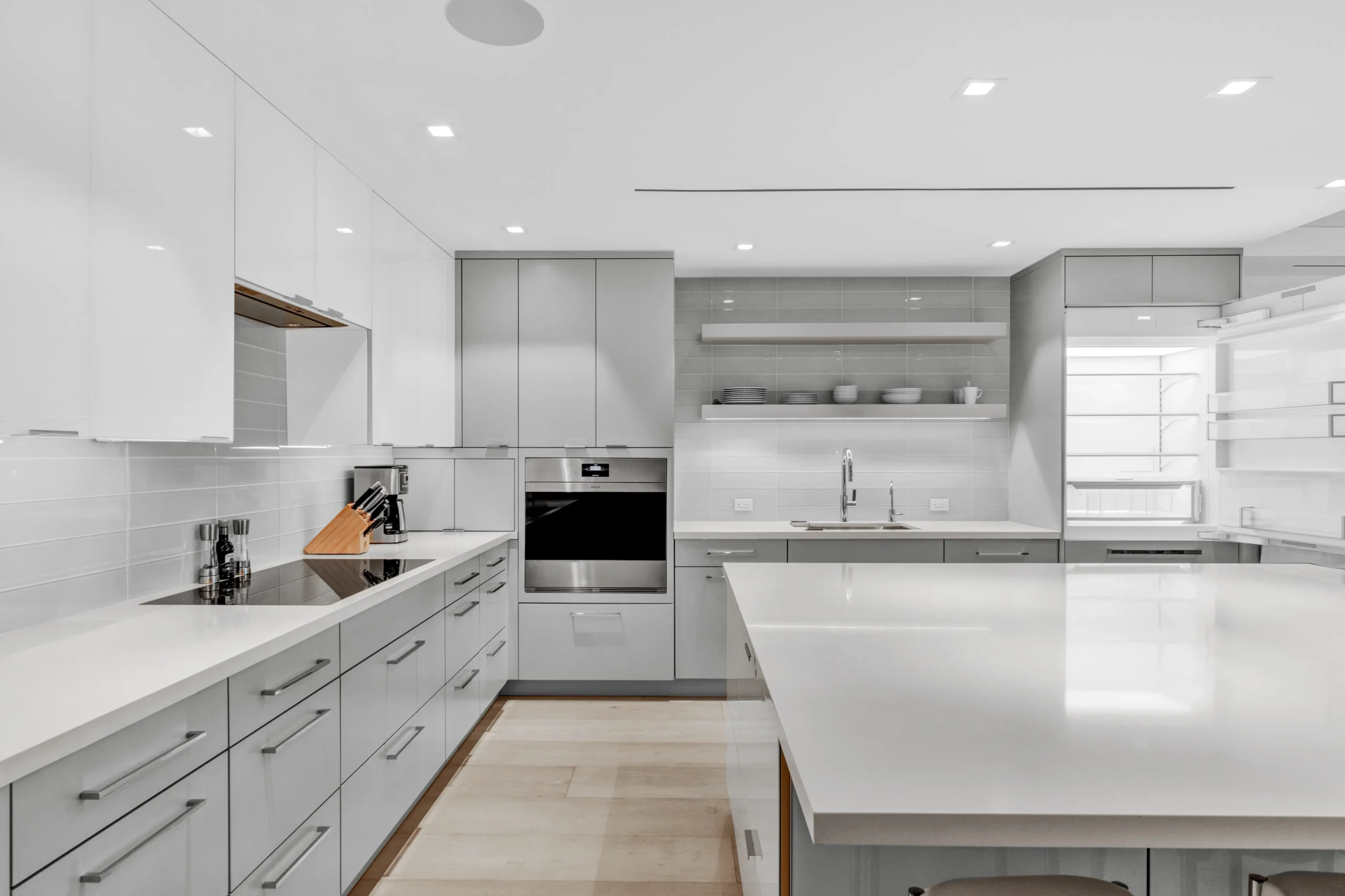 all white kitchen with white cabinetry.